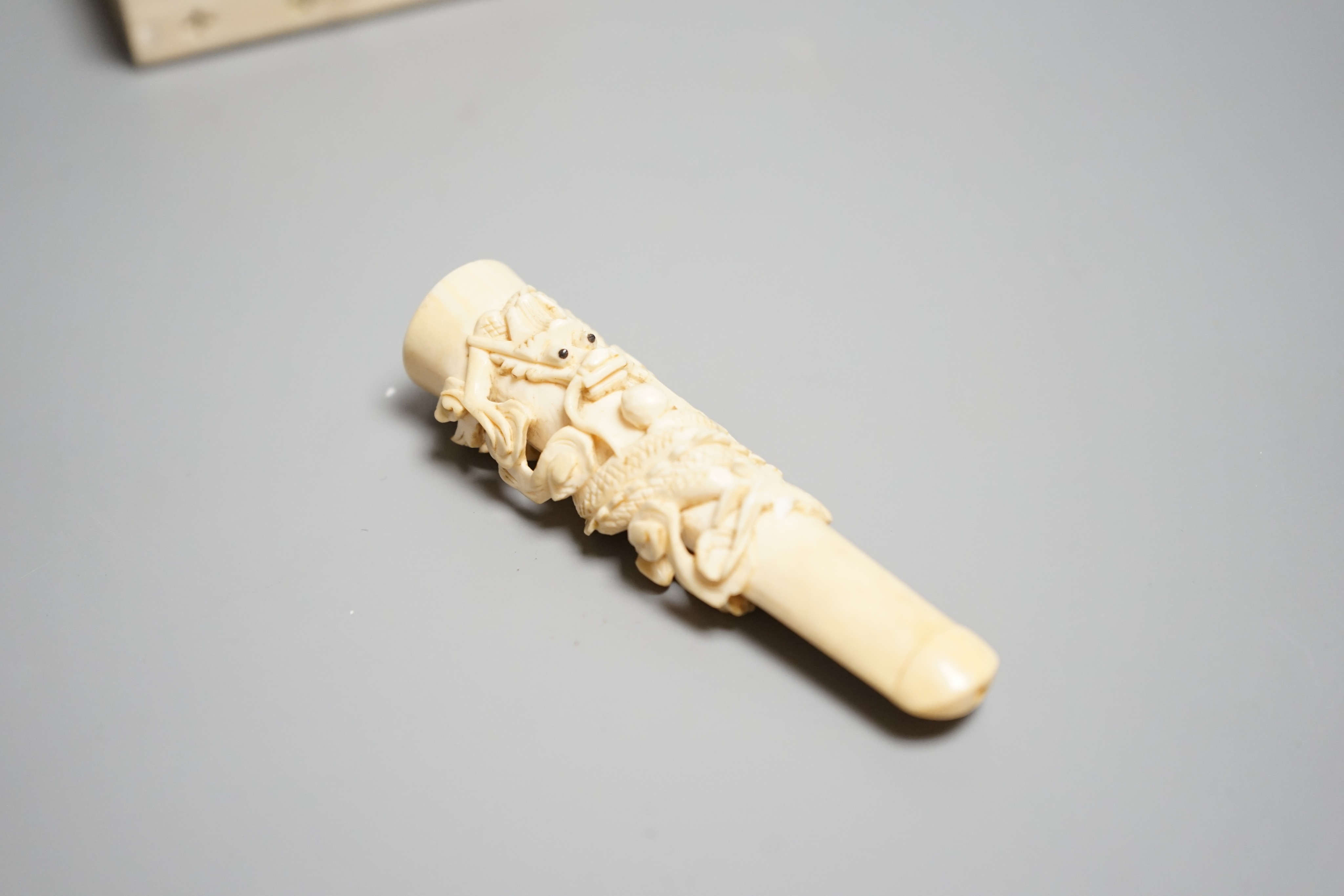 A Chinese ivory cigarette case, 8 x 6cm, and a Chinese carved ivory cheroot holder